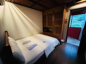 a bedroom with a white bed with two pillows at I Villa in in Kuala Lumpur