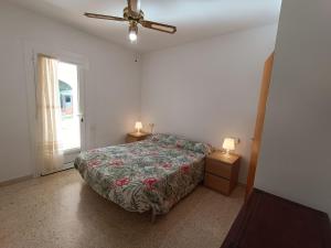 a bedroom with a bed and a ceiling fan at VILLA REPOSO in Calafat +43 photos