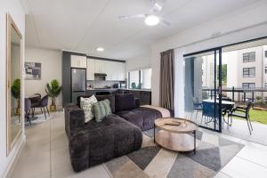 a living room with a couch and a table at Ballito Village Luxury Apartments in Ballito