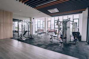 a gym with treadmills and machines in a room at K Avenue The Pillow House, 5 Minutes from KKIA in Penampang