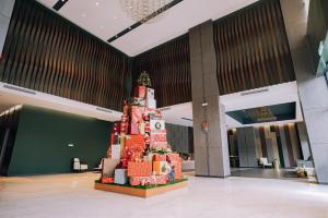 a christmas tree in the middle of a lobby at K Avenue The Pillow House, 5 Minutes from KKIA in Penampang
