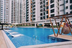 a large swimming pool in a city with tall buildings at K Avenue The Pillow House, 5 Minutes from KKIA in Penampang