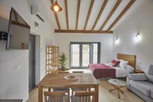 a living room with a bed and a table at Apartamentos Turísticos A Galera Ribadeo in Ribadeo