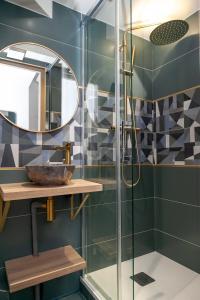 a bathroom with a shower with a sink and a mirror at Nets Inn Apartment - Gare de Lyon in Paris