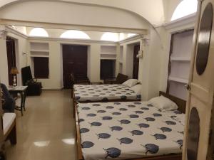 a bedroom with two beds in a room at Natraj Guest House in Ajmer