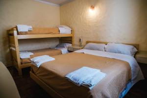 two beds in a room with two bunk beds at Hotel Panamericano in Barraquero