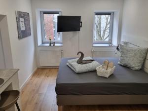 a room with a bed with two swans on it at City Central Apartment House in Kaiserslautern