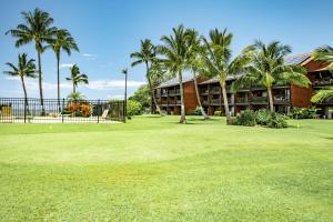 a resort with palm trees and a putting green at Molokai Shores in Kaunakakai