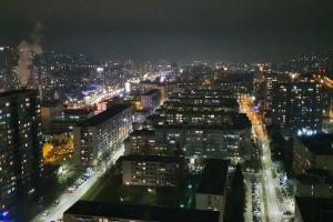 a view of a city at night with lights at Sarajevo Tower 24th floor apartment in Sarajevo