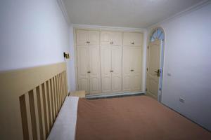 an empty room with a bed and a door at Bahia de Santiago in Puerto de Santiago