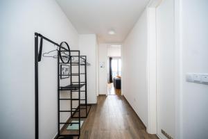 a staircase in a room with white walls and wooden floors at Sarajevo Tower 24th floor apartment in Sarajevo