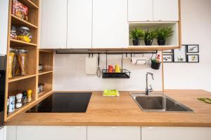 a kitchen with a sink and wooden counter top at Sarajevo Tower 24th floor apartment in Sarajevo