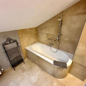 a bathroom with a bath tub and a shower at Ferienappartment Zürker in Garmisch-Partenkirchen