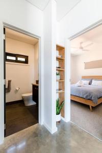 a bedroom with a bed and a bathroom with a tub at Flame Tree Retreat in Margaret River Town