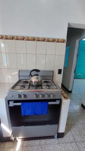 a kitchen with a stove with a pot on it at Casa de descanso Grace in San José de Guatemala
