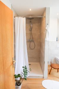 a shower with a shower curtain in a bathroom at Forsthaus Hubertus in Densberg