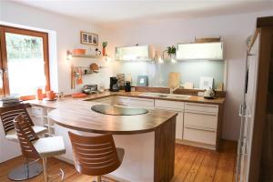 a kitchen with a large wooden table and chairs at Forsthaus Hubertus in Densberg