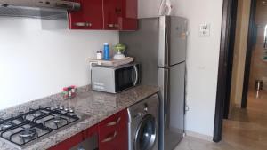 a kitchen with a refrigerator and a microwave at Family Home Downtown with Balcony, Casablanca in Casablanca
