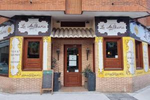 a store front of a brick building with wooden doors at (J1) Ubicado en Madrid Centro - 5 personas. in Madrid