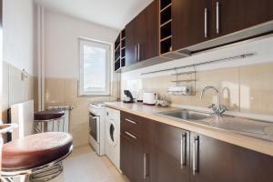 a kitchen with a sink and a washing machine at Studio 37 by MRG Apartments in Bucharest
