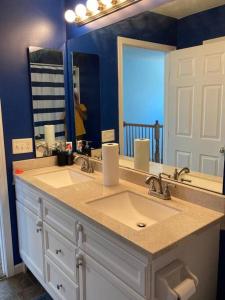 a bathroom with a sink and a large mirror at Feel at Home, 7mn to Airport, 15 mn to Downtown. in Vandalia