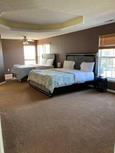 a large bedroom with two beds and two windows at Feel at Home, 7mn to Airport, 15 mn to Downtown. in Vandalia