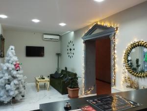 a living room with a christmas tree and a mirror at NRS Hotel in Baku