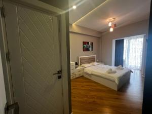 a small bedroom with a bed and a door at Park Azure 11523 in Baku