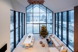 a living room with a christmas tree and a couch at Boskata Spa & Wellness Resort Ślesin in Mikorzyn