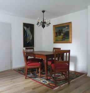 a dining room table with four chairs and a chandelier at Ferienhaus alte Försterei in Malchin