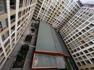 an overhead view of a walkway between two tall buildings at Park Azure 11523 in Baku