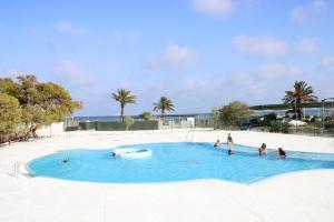 a group of people in a swimming pool at a resort at Bungalows Mar Menor, paz a orillas del mar in San Javier +41 photos