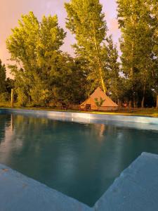 a large pool of water with a tent in the background at Vivac Camp in San Rafael