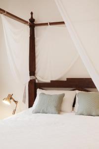 a bedroom with a bed with white sheets and pillows at Appartements 4 vents by La Boîte En Plus in Senlis +46 photos
