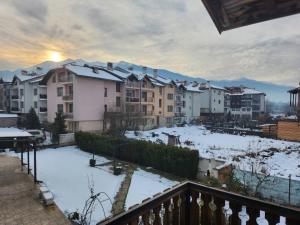 a view of a city in the snow at Guest House Stoyanov in Bansko