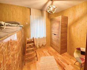 a room with a bunk bed and a ladder and a closet at ПростоРа in Khalepʼye