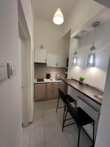 a kitchen with a table and chairs in a room at Goldensun Apartment in Budapest