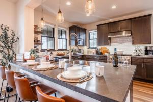a large kitchen with a large island with chairs at Creekhouse 1364 in Mammoth Lakes