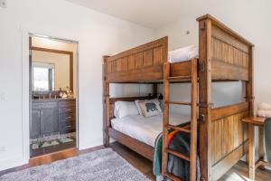 a bedroom with bunk beds and a mirror at Creekhouse 1364 in Mammoth Lakes