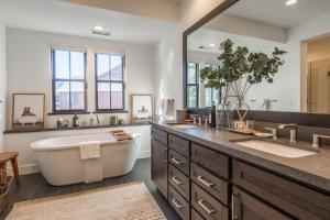 a bathroom with a tub and a large mirror at Creekhouse 1364 in Mammoth Lakes +61 photos