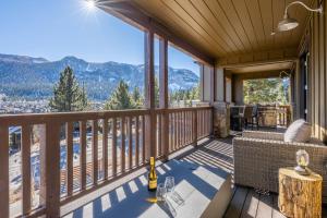 a deck with a table and chairs on a balcony at Creekhouse 1364 in Mammoth Lakes