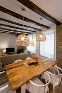 a dining room with a wooden table and chairs at Casa Santiago casa rural in Tivenys
