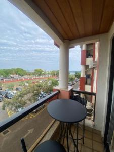 a balcony with a table and a view of a parking lot at MODERNO FLAT LAKE SIDE in Brasilia
