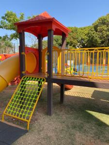 a playground with a slide in a park at MODERNO FLAT LAKE SIDE in Brasilia