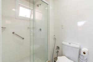 a bathroom with a glass shower and a toilet at Rua Coberta de Canela @stayhousetemporada in Canela +20 photos