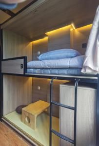 two bunk beds in a room with a table at 不负韶华青年旅馆 Youth Hostel in Suzhou