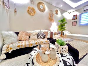 a living room with a couch and a table at Boho lovely - بتسجيل وصول ذاتي in Riyadh