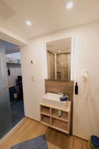 a bathroom with a sink and a mirror at Ferienhaus Schöne Aussicht Ferienwohnung Blau in Hemfurth-Edersee