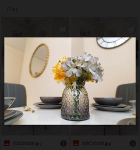 a vase filled with flowers sitting on a table at St James House - Sleeps 8! in Leeds