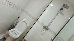 a bathroom with a toilet and a glass shower stall at loft d'exception à Gauthier in Casablanca